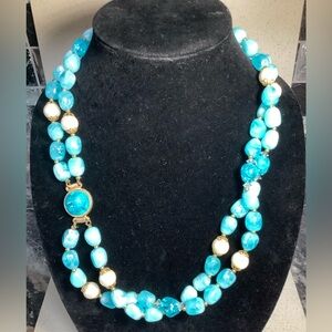 Elegant Blue resin, faux pearl , and gold accent Necklace with hook closure.